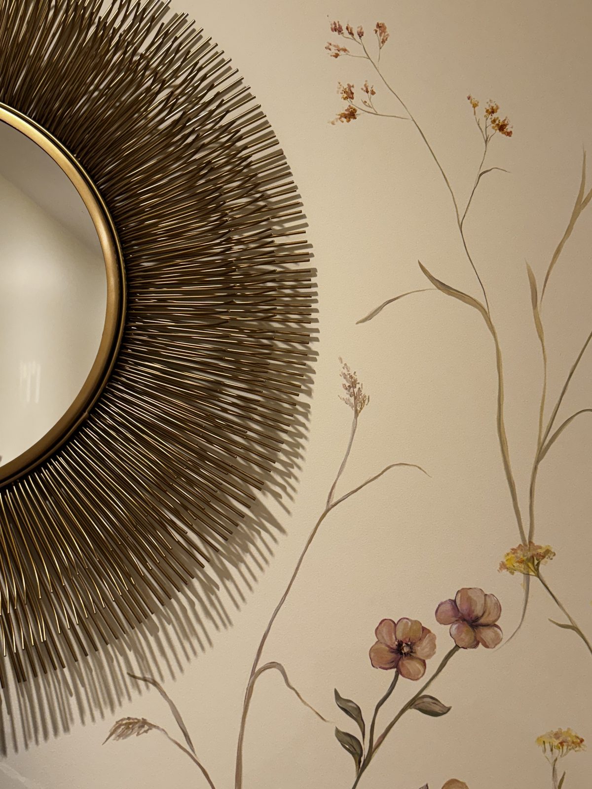 Wildflower mural detail beside a mirror